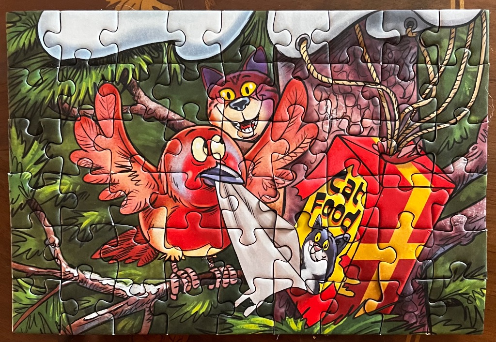 Cartoony red bird & cat near red cat food bag with yellow stripes.