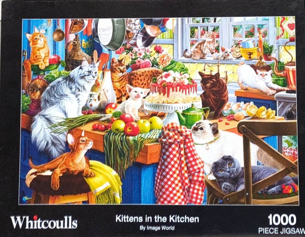 A kitchen interior filled with several kittens and cats interacting with food and cookware.