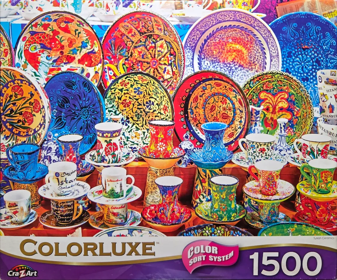 A vibrant display of colorful Turkish ceramic plates and tea cups featuring intricate floral and landmark patterns.