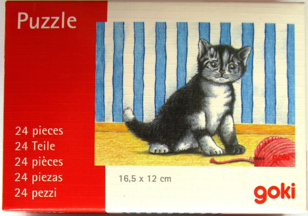 A drawing of a small black and white kitten sitting on a floor next to a ball of red yarn.