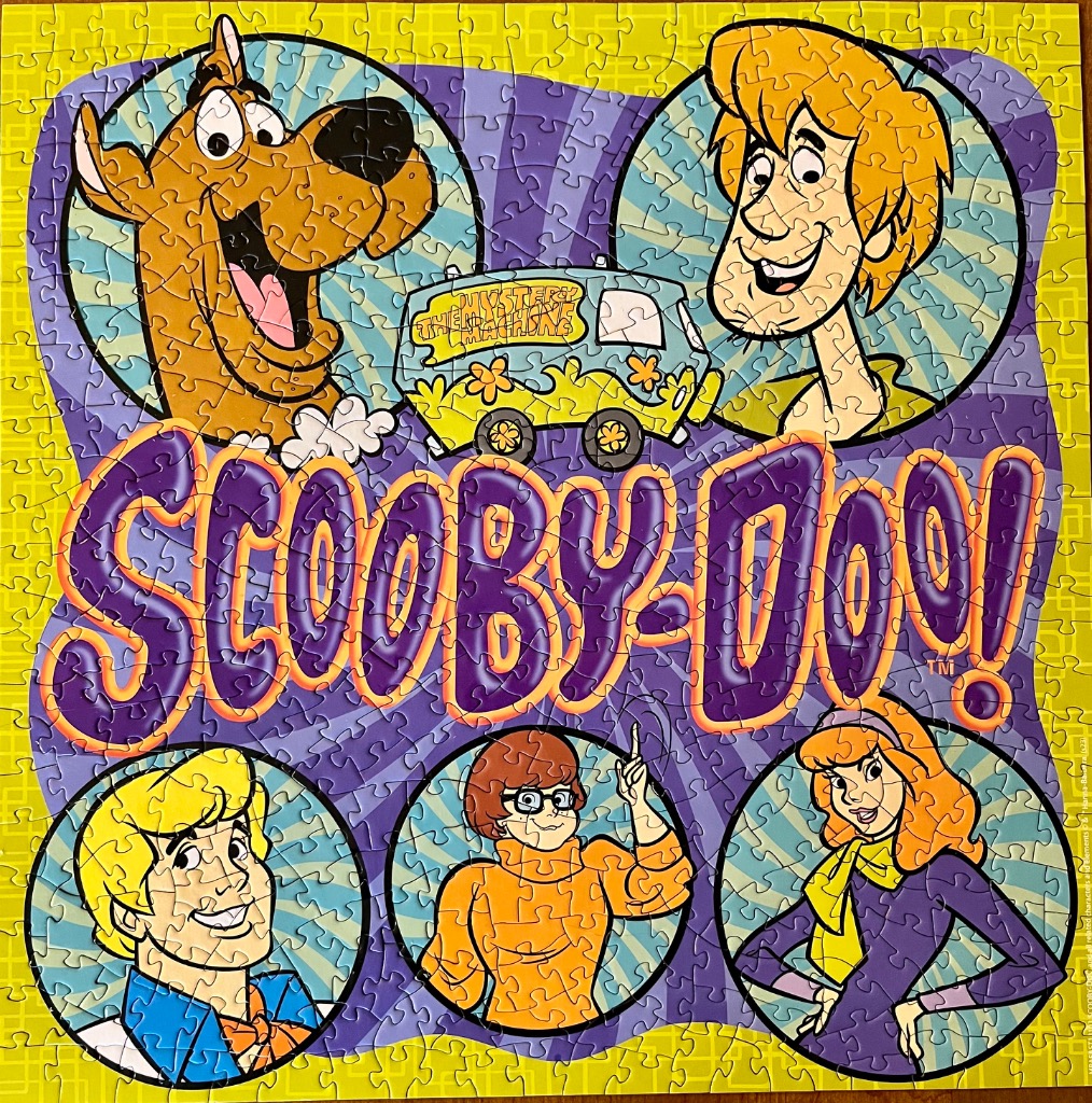 Cartoon illustration featuring the Scooby-Doo gang, the Mystery Machine, and the Scooby-Doo logo.