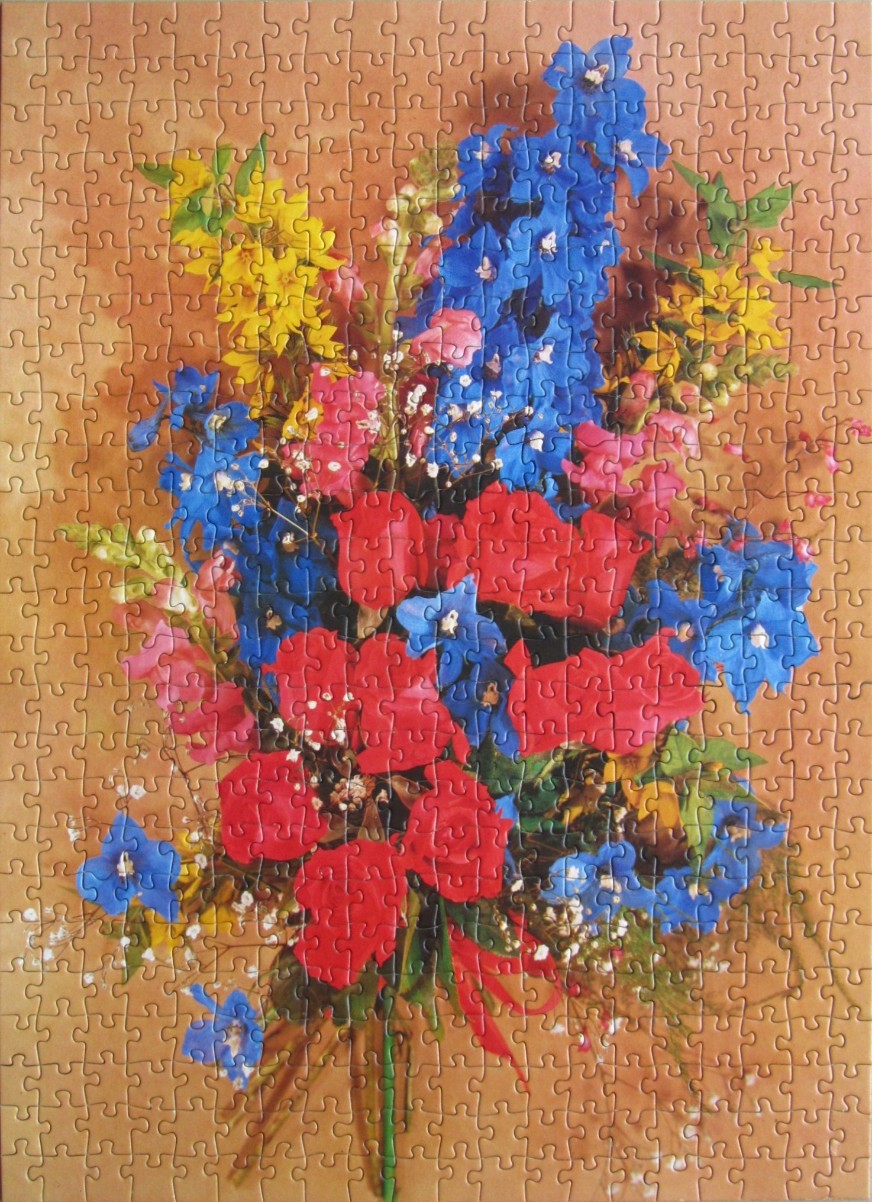A vibrant floral arrangement of blue, red, and yellow flowers against a warm tan background.