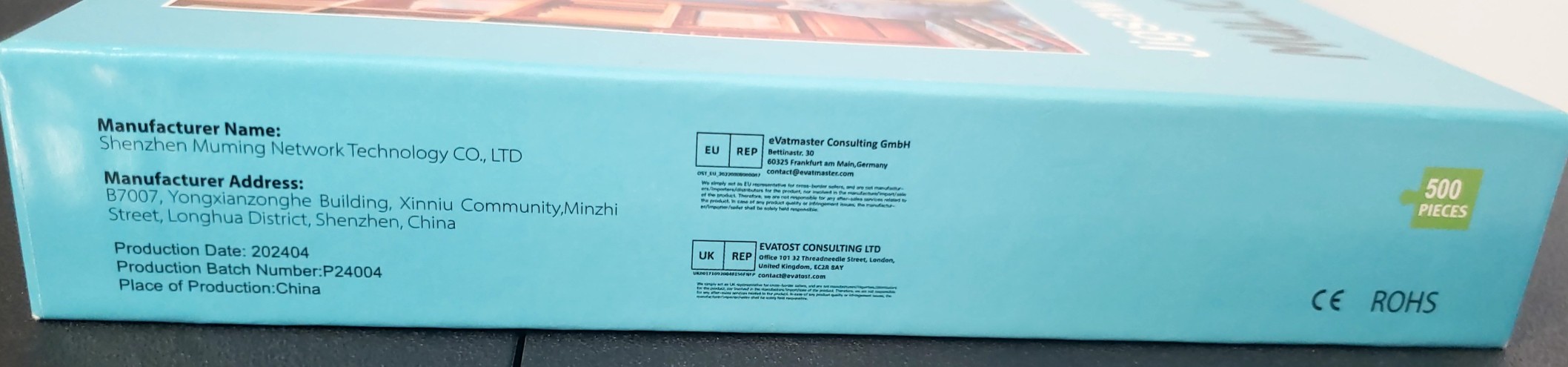A close-up view of a product box side panel featuring manufacturer and production information.
