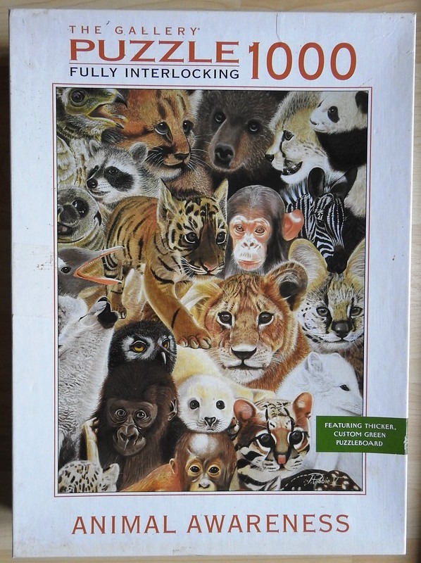 A montage of various animal portraits including big cats, primates, a panda, and a zebra.