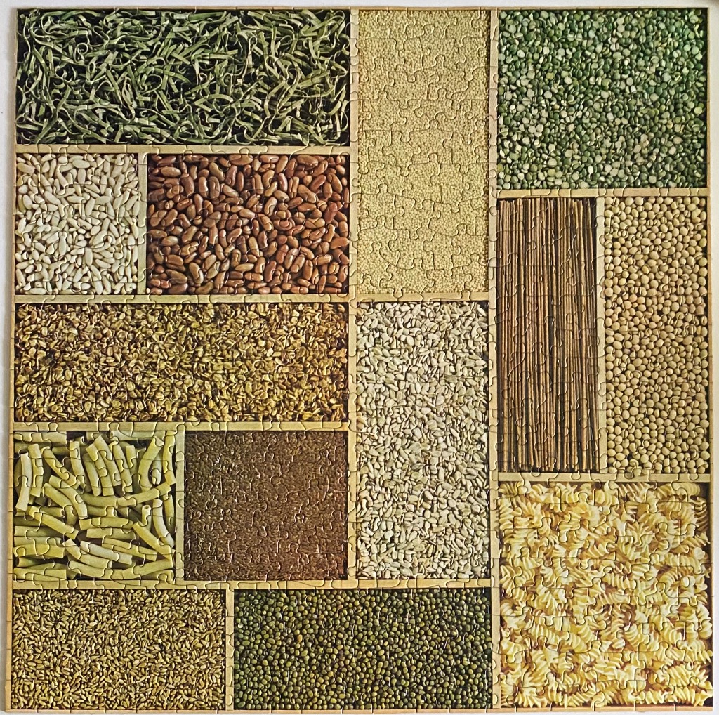 A collage of various dry grains, legumes, and pasta arranged in a rectangular grid pattern.