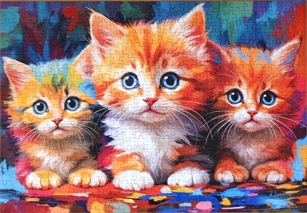 A vibrant oil-style painting featuring three fluffy orange kittens with bright blue eyes side-by-side.