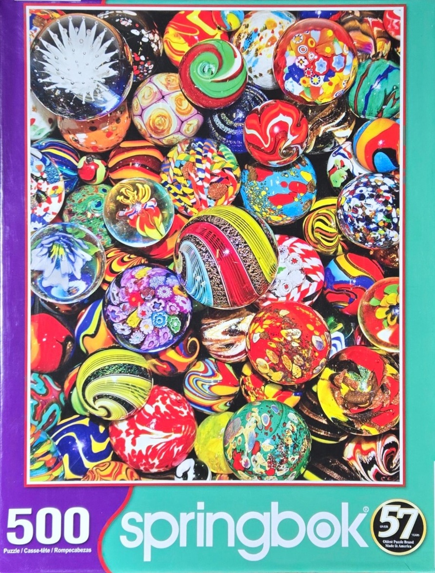 A dense collection of colorful decorative glass marbles and paperweights.