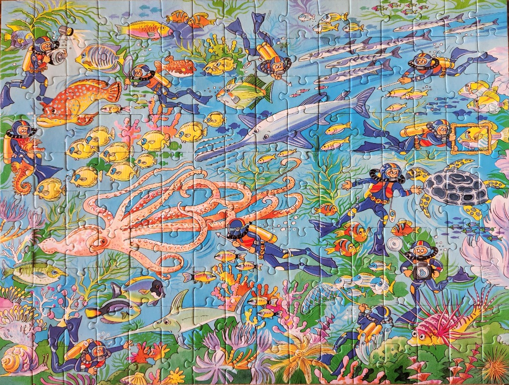 A vibrant cartoon illustration of scuba divers exploring a bustling coral reef filled with various fish and sea life.