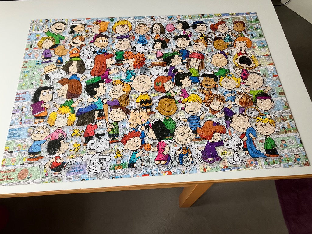 A dense collage of many Peanuts characters and comic strips featuring Snoopy, Charlie Brown, and others.