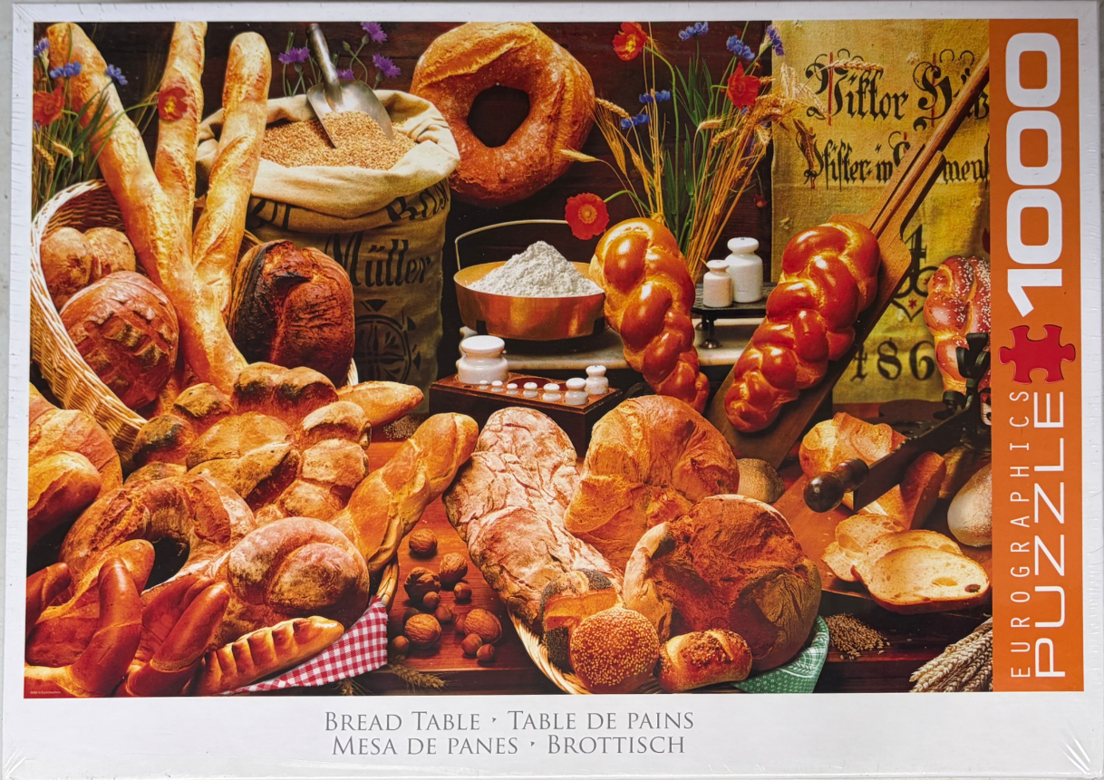 A still life arrangement featuring a wide variety of freshly baked breads, loaves, and baking ingredients.