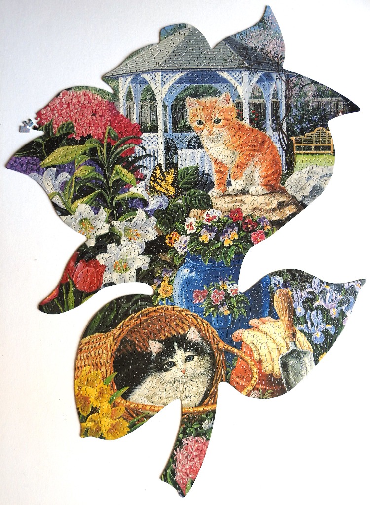 An illustration of two kittens in a lush garden setting with a gazebo and flowers.