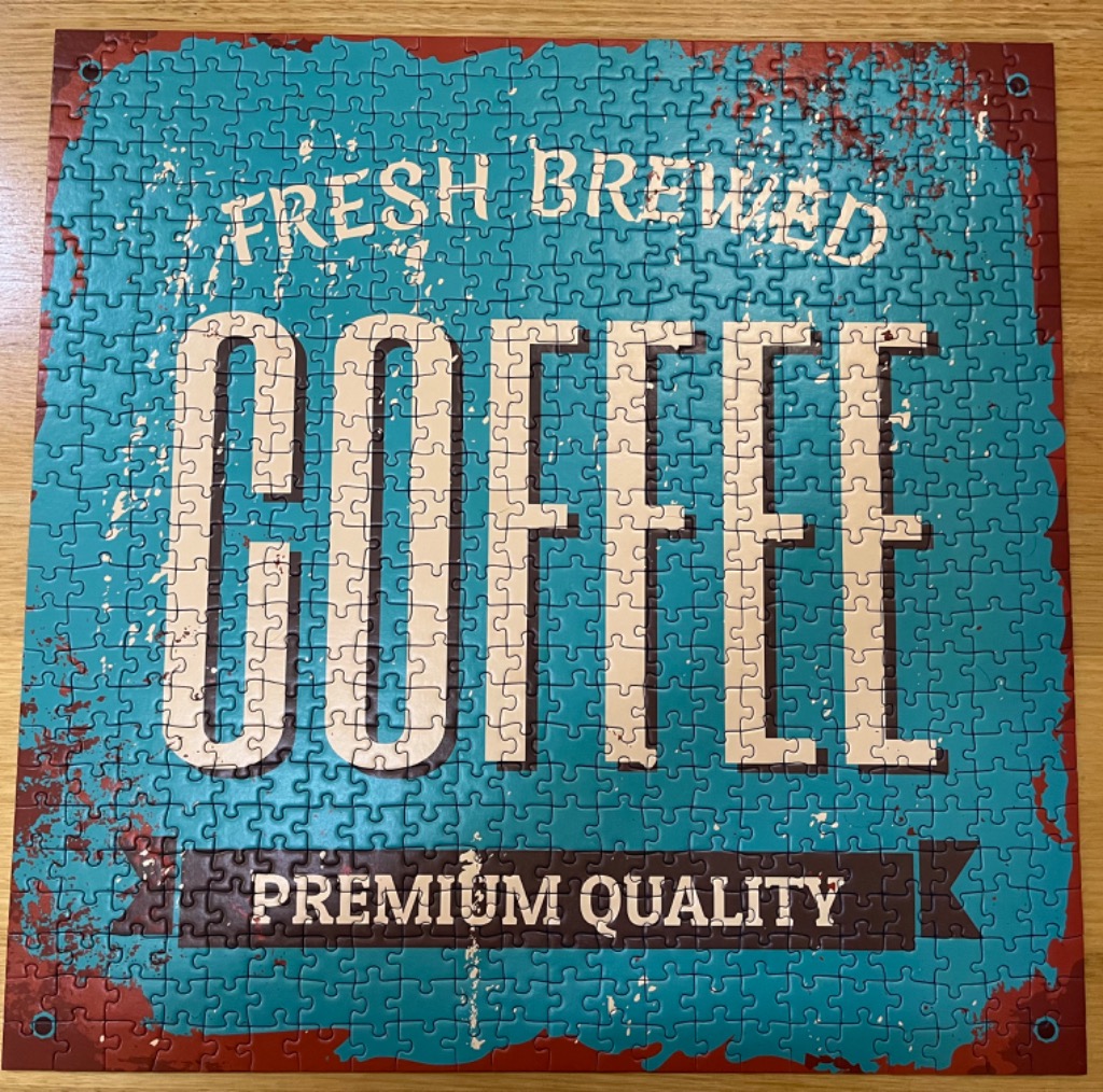 Vintage-style sign that reads FRESH BREWED COFFEE PREMIUM QUALITY in white text on a teal and rusted red background.