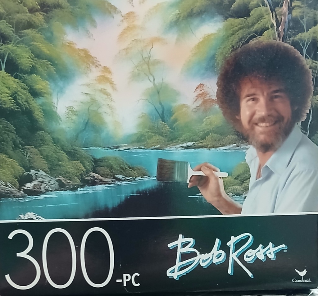 Bob Ross painting a lush landscape with a river and green forest