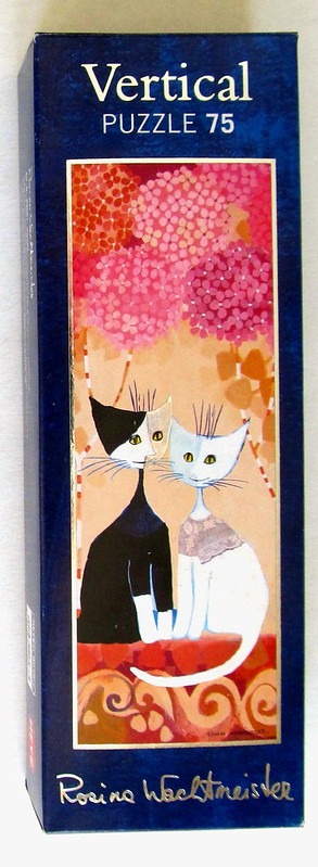 Two stylized cats, one black and one white, sitting under pink floral blossoms in a whimsical folk-art style.