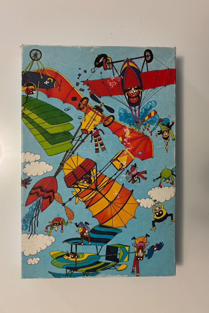 A whimsical illustration of several vintage-style, colorful flying machines and falling pilots against a light blue sky.