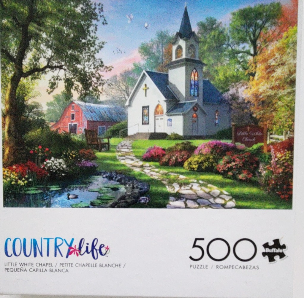 A peaceful country scene featuring a small white church, a stone path, a pond, and a red barn at sunset.