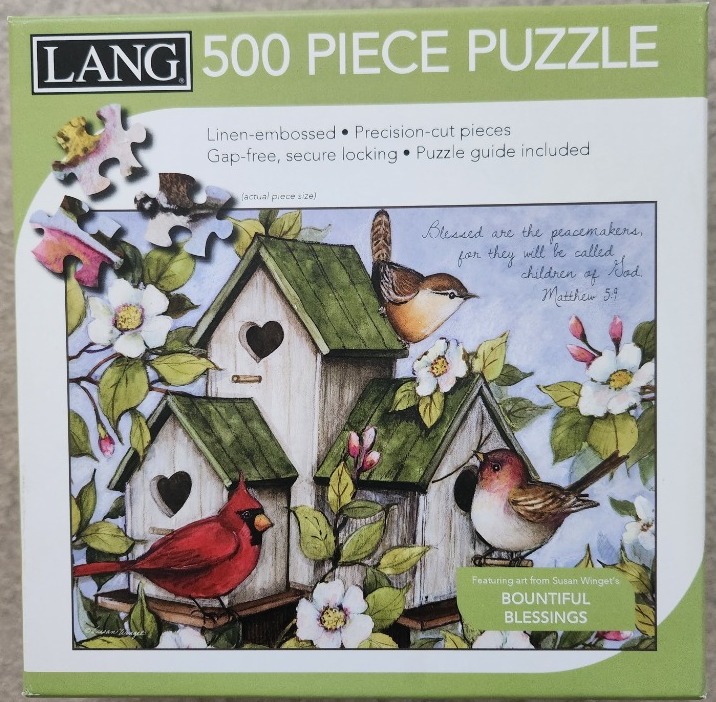 Watercolor illustration of songbirds and wooden birdhouses surrounded by white blossoms.