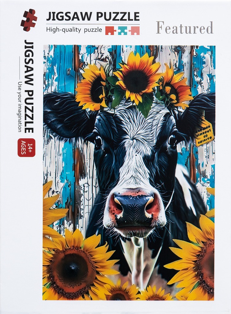 A black and white cow wearing a sunflower crown against a rustic blue wooden background surrounded by sunflowers.