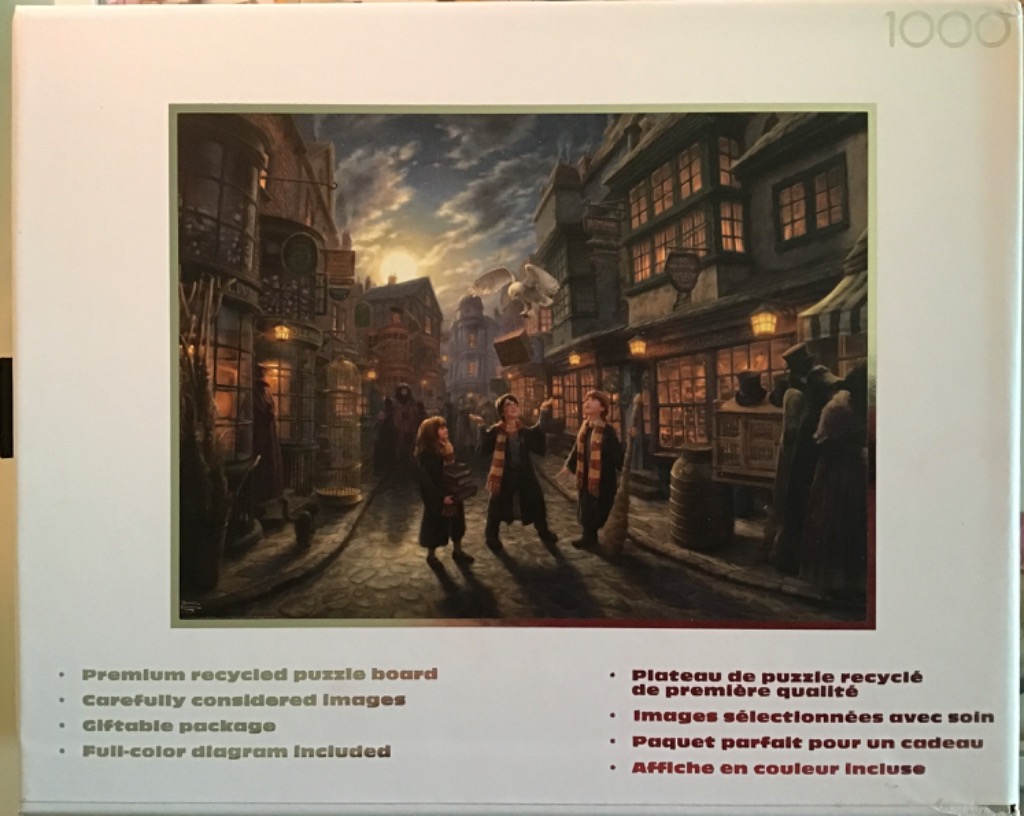 Three young students in robes standing on a cobblestone street in a magical shopping alley at dusk.