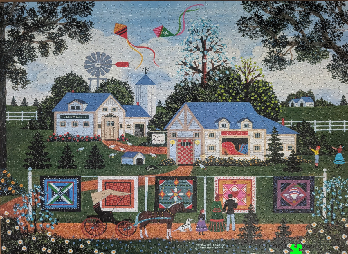 Folk art scene of a rural cottage with quilts hanging on a line, a horse-drawn carriage, and flying kites.