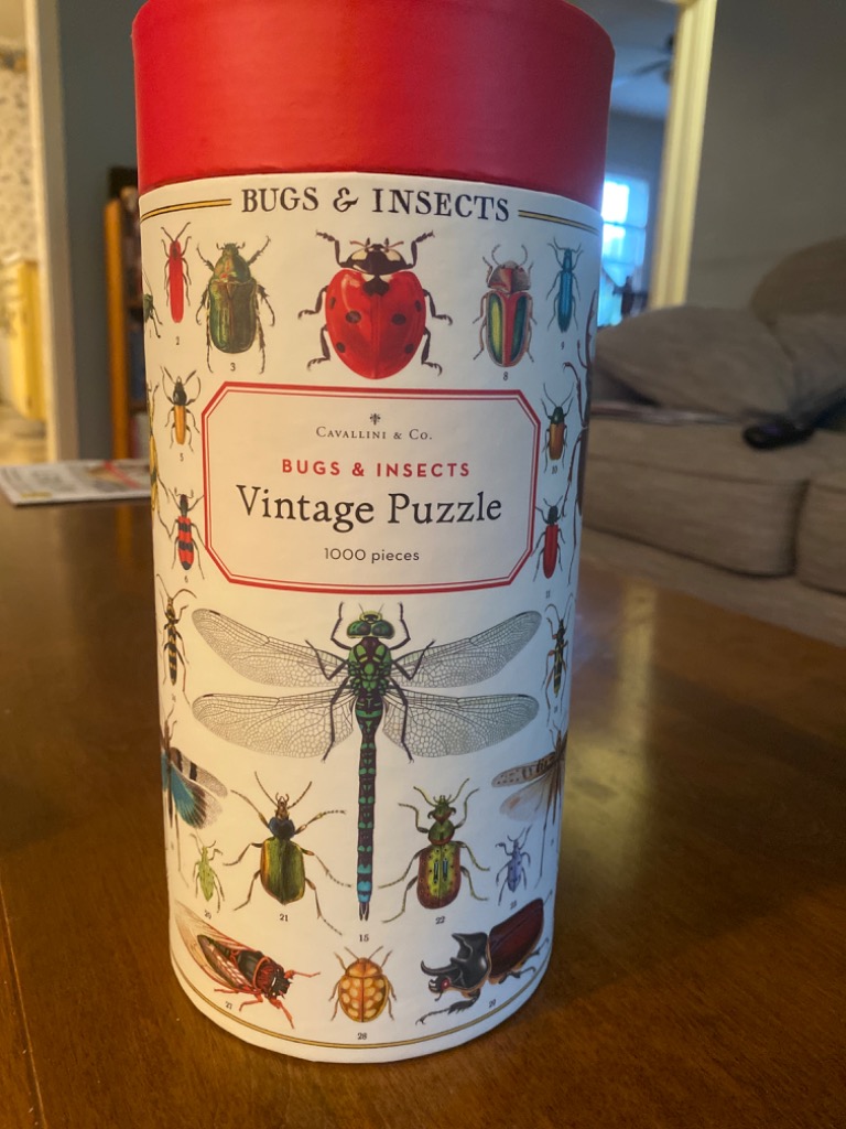 A cylindrical container featuring vintage illustrations of various bugs and insects on a white background.