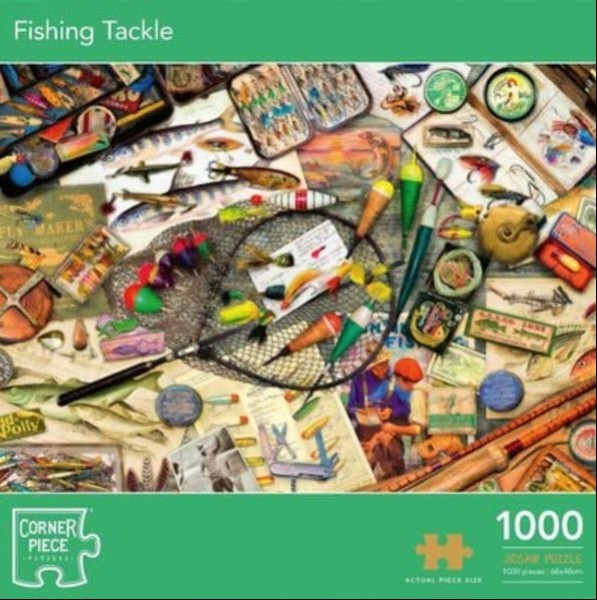 A cluttered tabletop covered in vintage fishing gear, including flies, lures, nets, and old instruction booklets.
