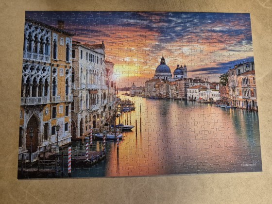 Venetian canal scene at sunset featuring historic architecture and the Basilica di Santa Maria della Salute