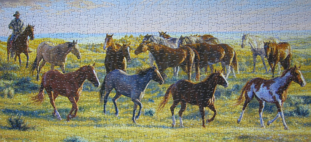 A cowboy on horseback leads a large herd of horses across a vast, golden prairie under a twilight sky.