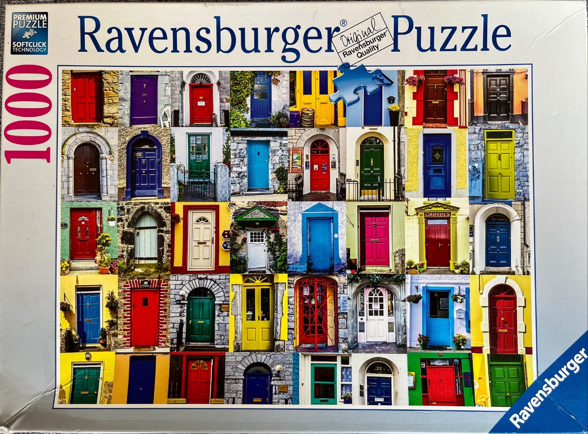A collage of thirty-five colorful exterior doors from various homes arranged in a grid.