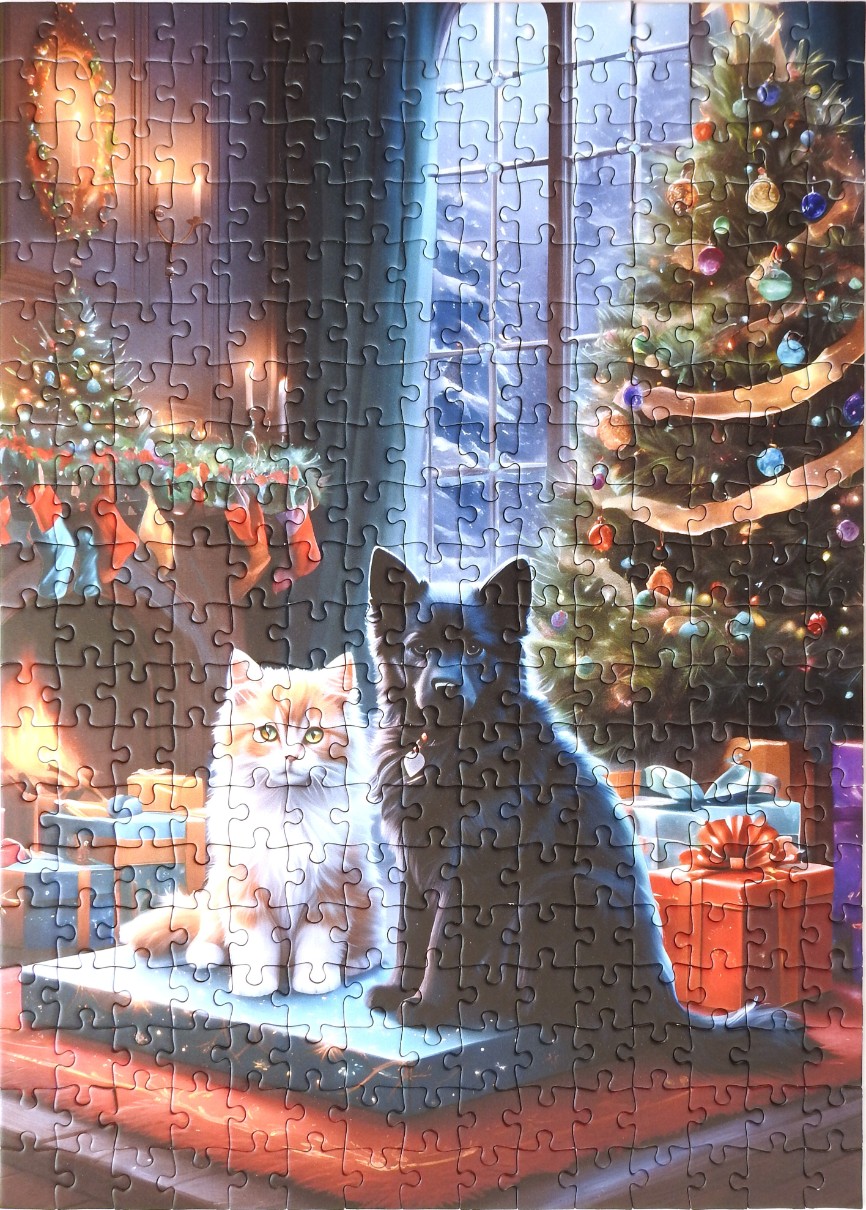 A fluffy orange cat and a black dog sitting together in front of a decorated Christmas tree.