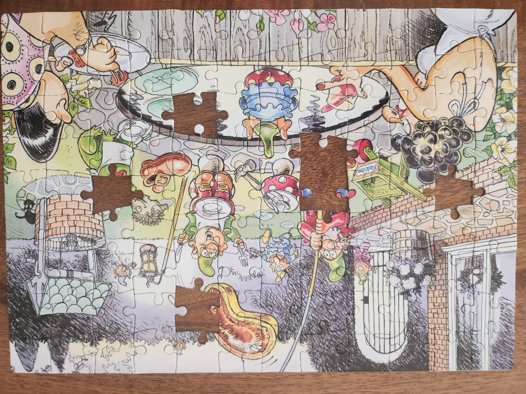 Whimsical cartoon scene of gnomes having a picnic and playing outside a brick building.