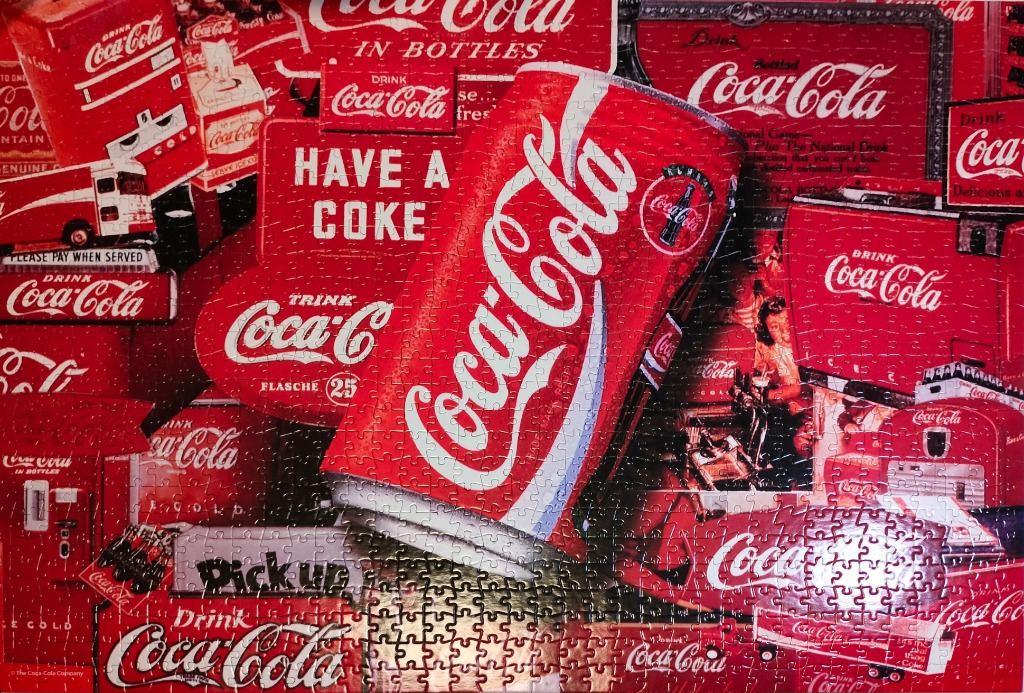 A collage of vintage Coca-Cola advertisements, signs, and imagery featuring a prominent soda can in the center.