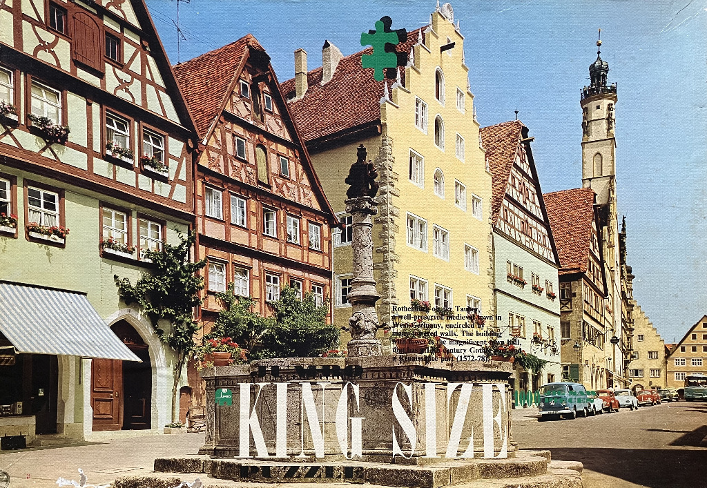 Street scene in Rothenburg ob der Tauber with historic timber-framed buildings and a central stone fountain.