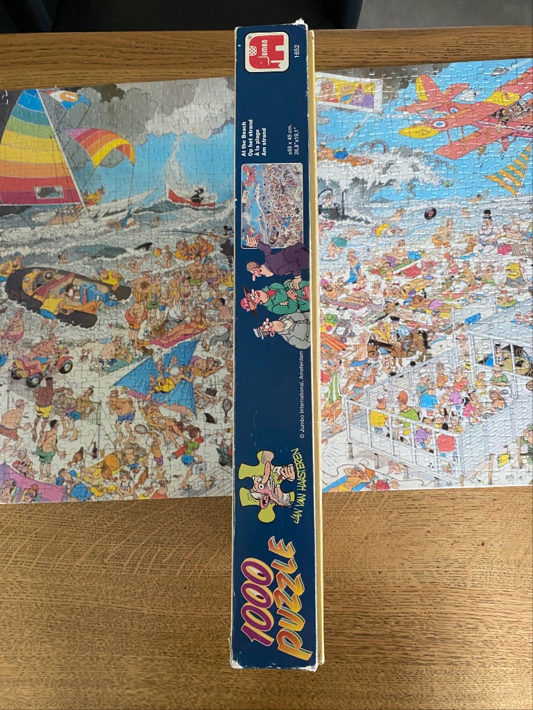 A chaotic cartoon illustration of a busy, crowded beach scene with people and various funny mishaps.
