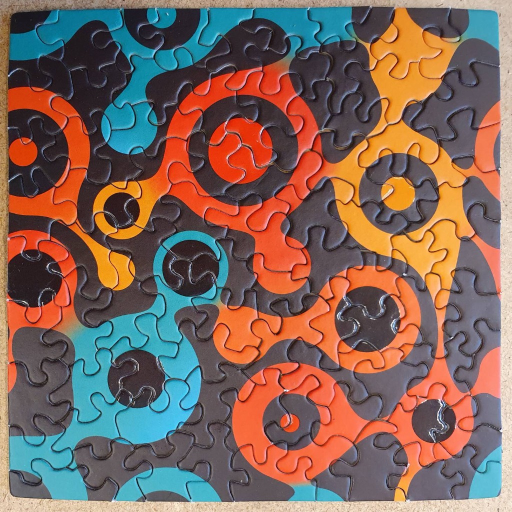Abstract design of overlapping circles and flowing organic shapes in teal, orange, and dark grey.