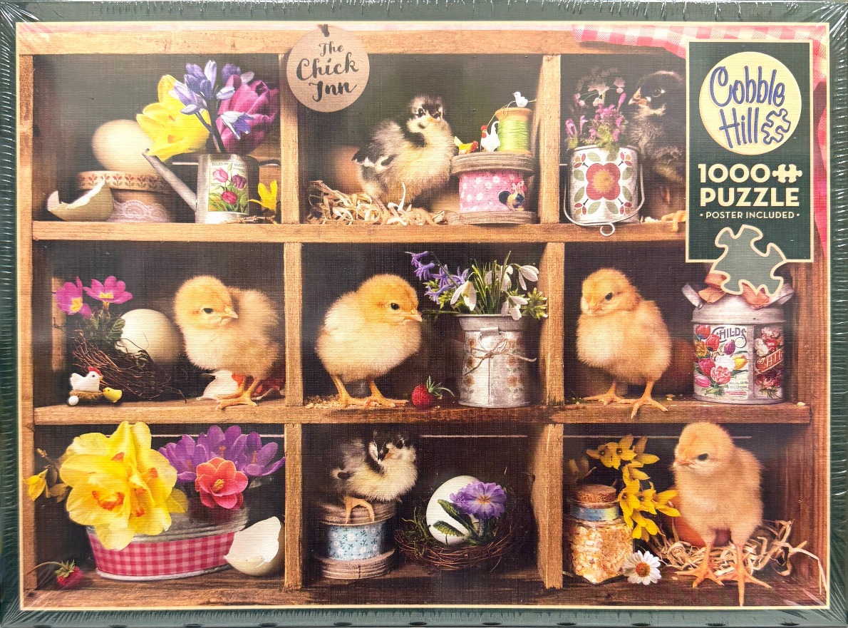A wooden shelf with nine compartments filled with fluffy baby chicks, spring flowers, and vintage craft items.