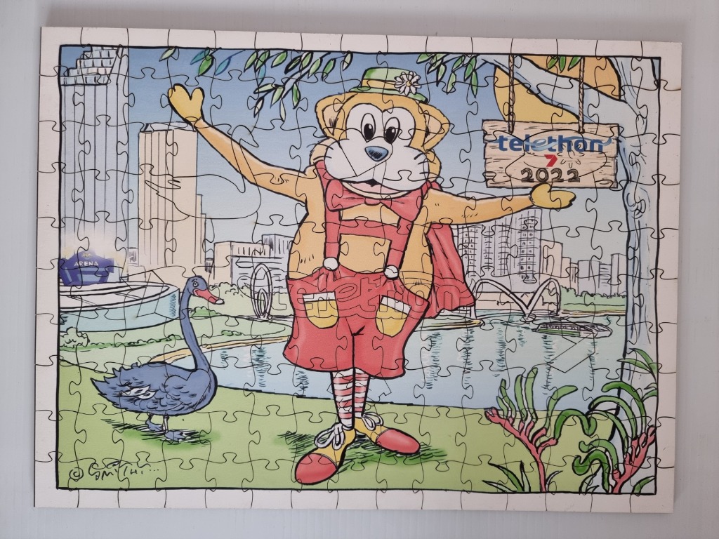 Cartoon mascot character in a park setting with Perth skyline background