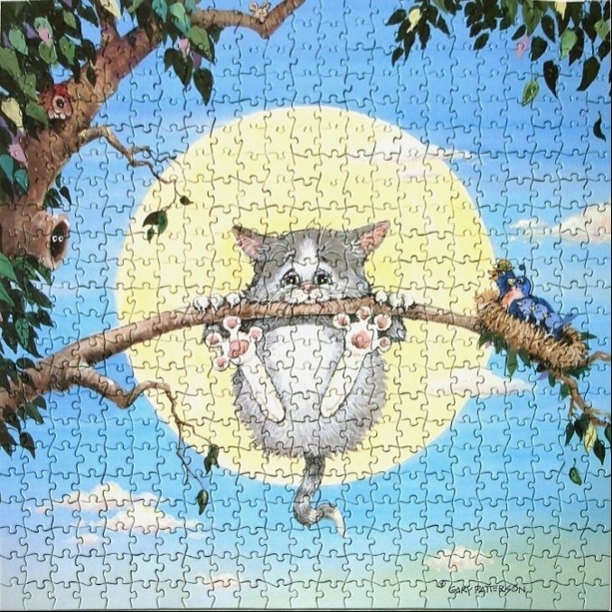 A cartoon grey kitten hanging precariously from a tree branch in front of a large sun.