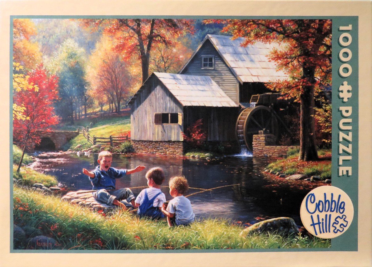 Three young boys fishing by a creek in front of an old wooden water mill during autumn.