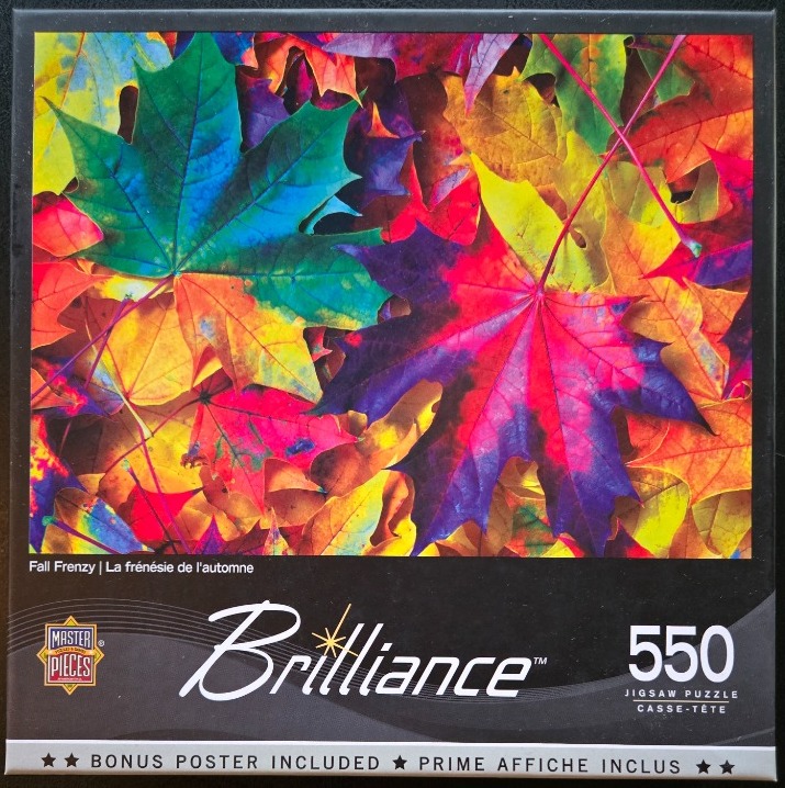 A close-up, vibrant photograph of overlapping maple leaves in a spectrum of rainbow colors.