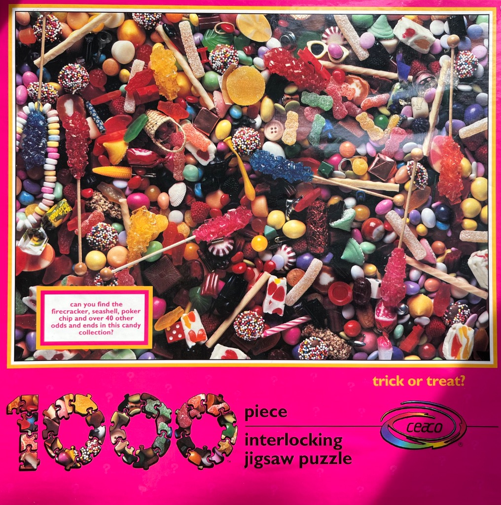A dense, colorful collection of scattered candies, sweets, and small household items.