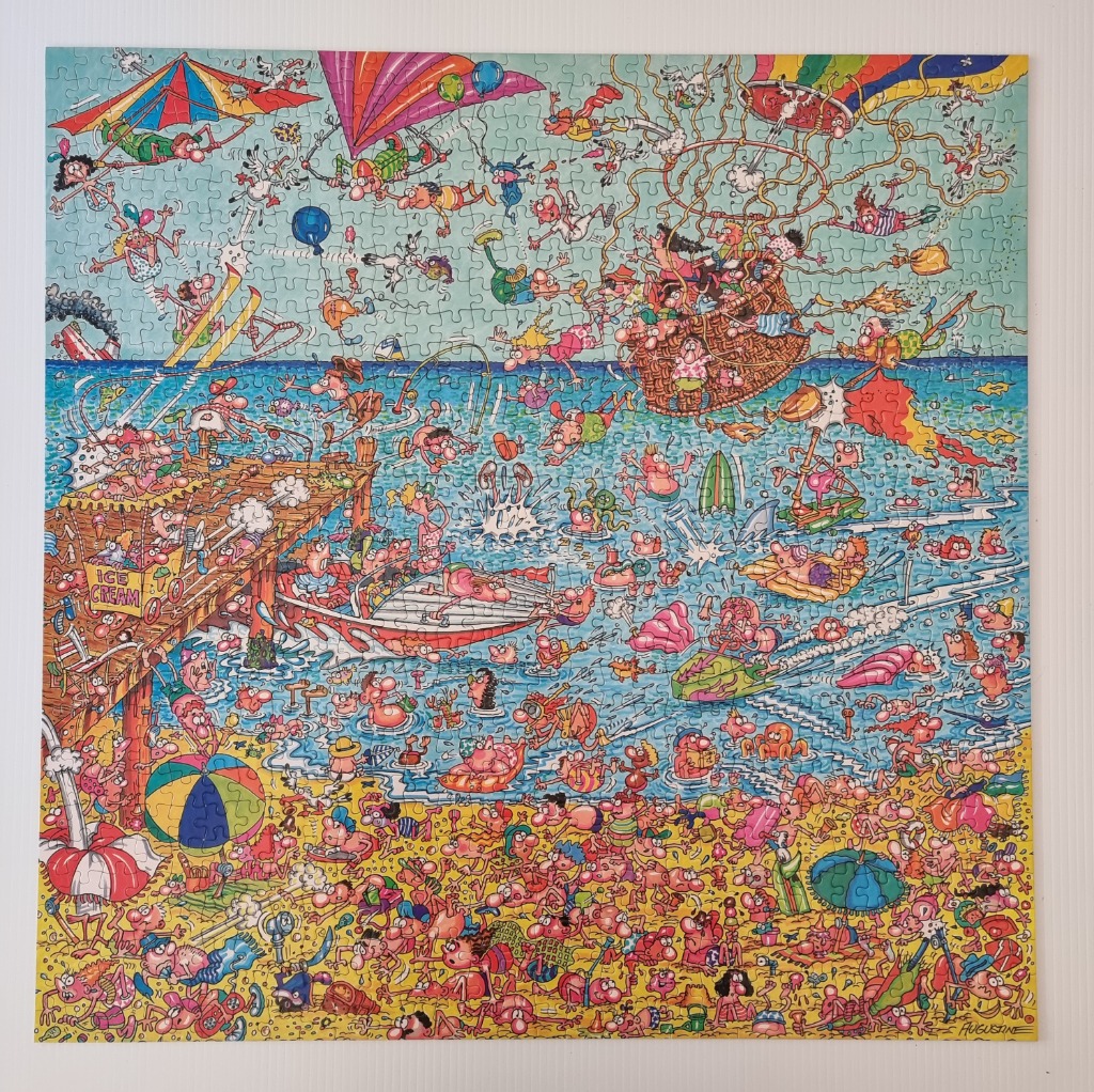 A chaotic, humorous cartoon scene featuring a crowded beach, ocean activities, and a sky filled with flying people.