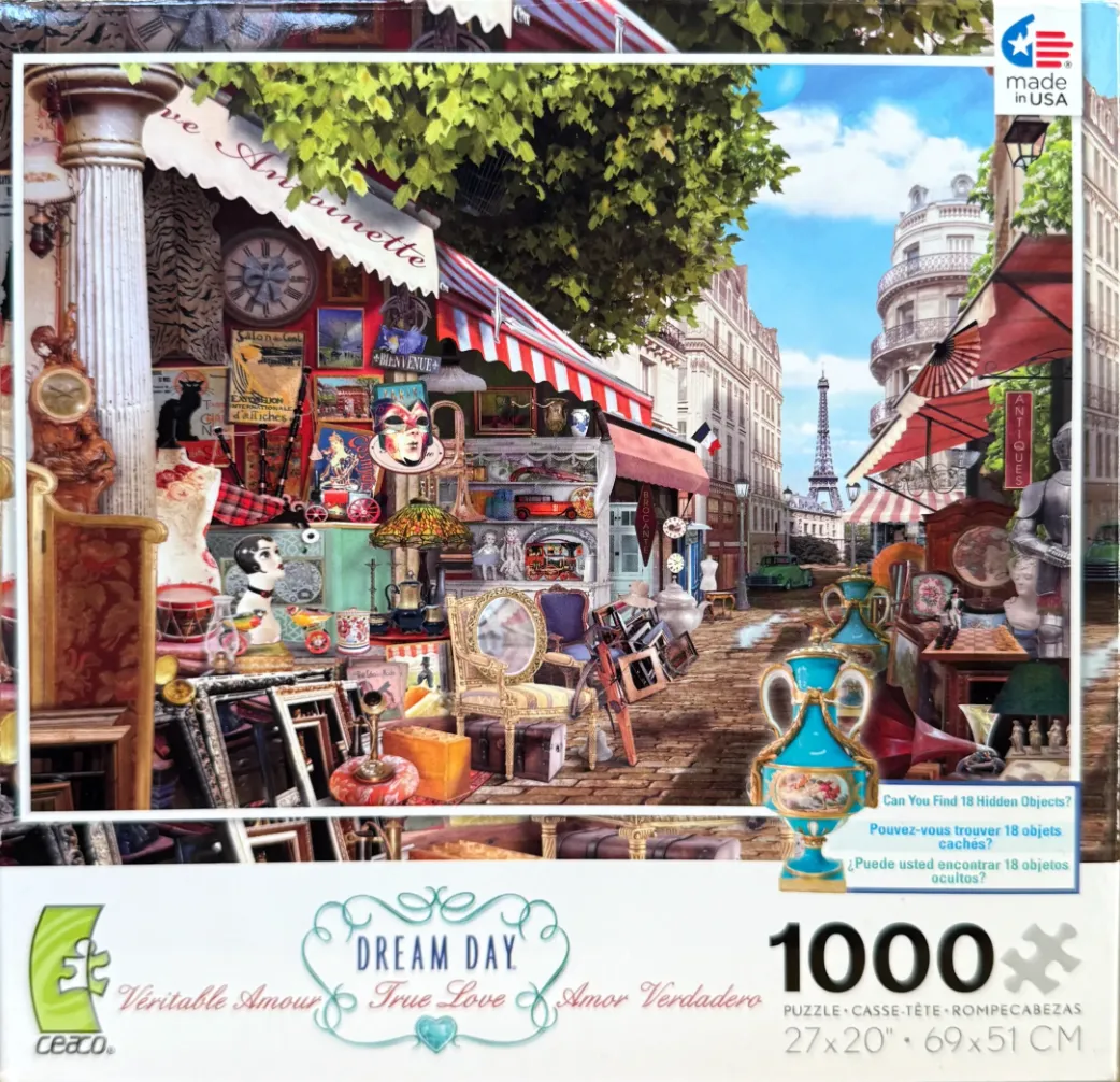 An outdoor Parisian antique market scene with the Eiffel Tower in the distance.
