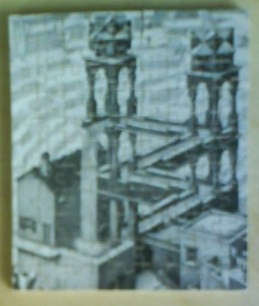 An Escher-style black and white illustration of an impossible architectural structure featuring winding stairways.