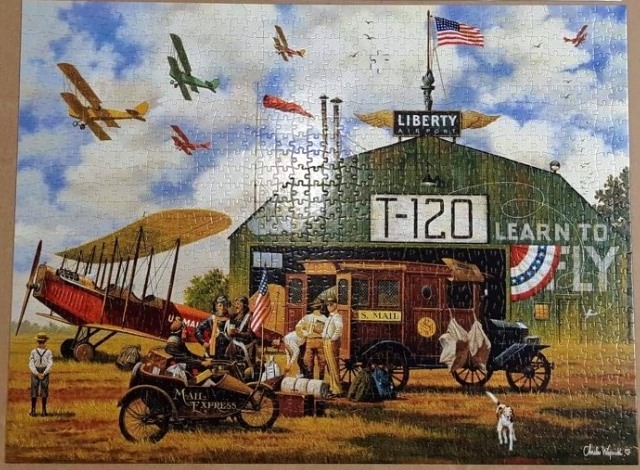 Vintage illustration of a 1920s-era airport hangar with biplanes and a US Mail truck.