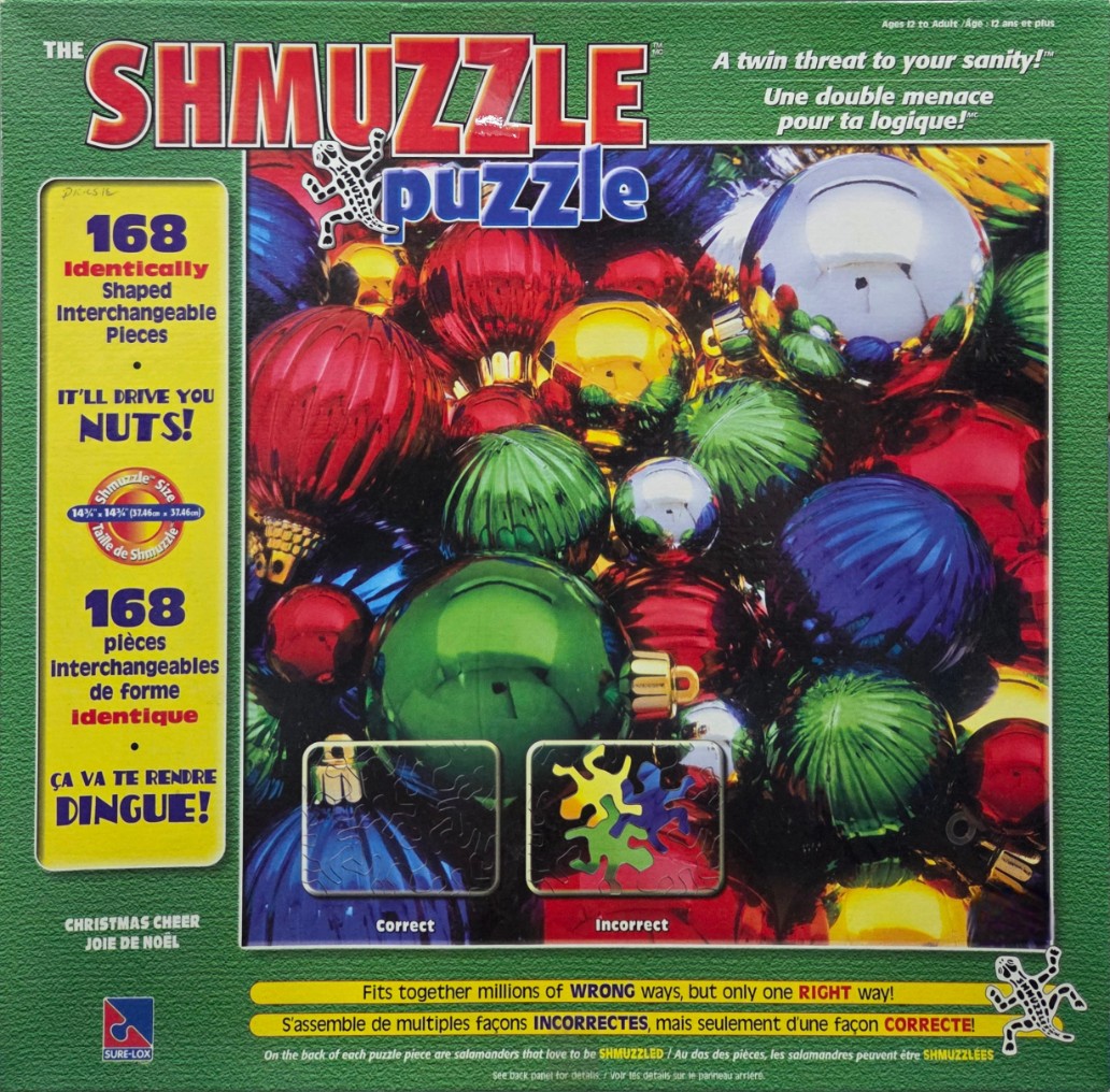 A close-up photograph of a colorful collection of shiny Christmas baubles in red, green, blue, and gold.