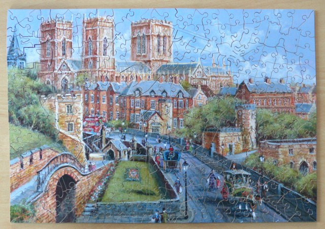 Painting of a historic British city scene featuring a large cathedral and a horse-drawn carriage in the street.