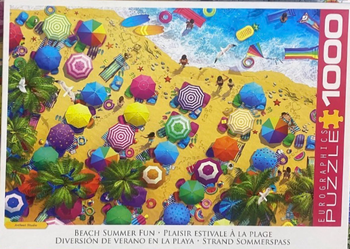Aerial view of a crowded beach filled with colorful umbrellas and sunbathers.