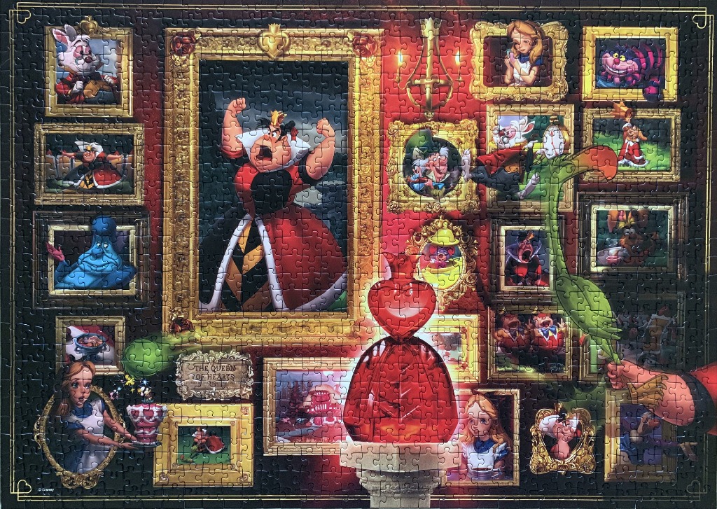 A gallery wall featuring the Queen of Hearts and various scenes and characters from Alice in Wonderland.