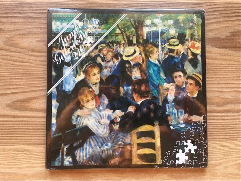 Impressionist painting of a lively crowd at an outdoor cafe, known as Bal du moulin de la Galette by Pierre-Auguste Renoir.